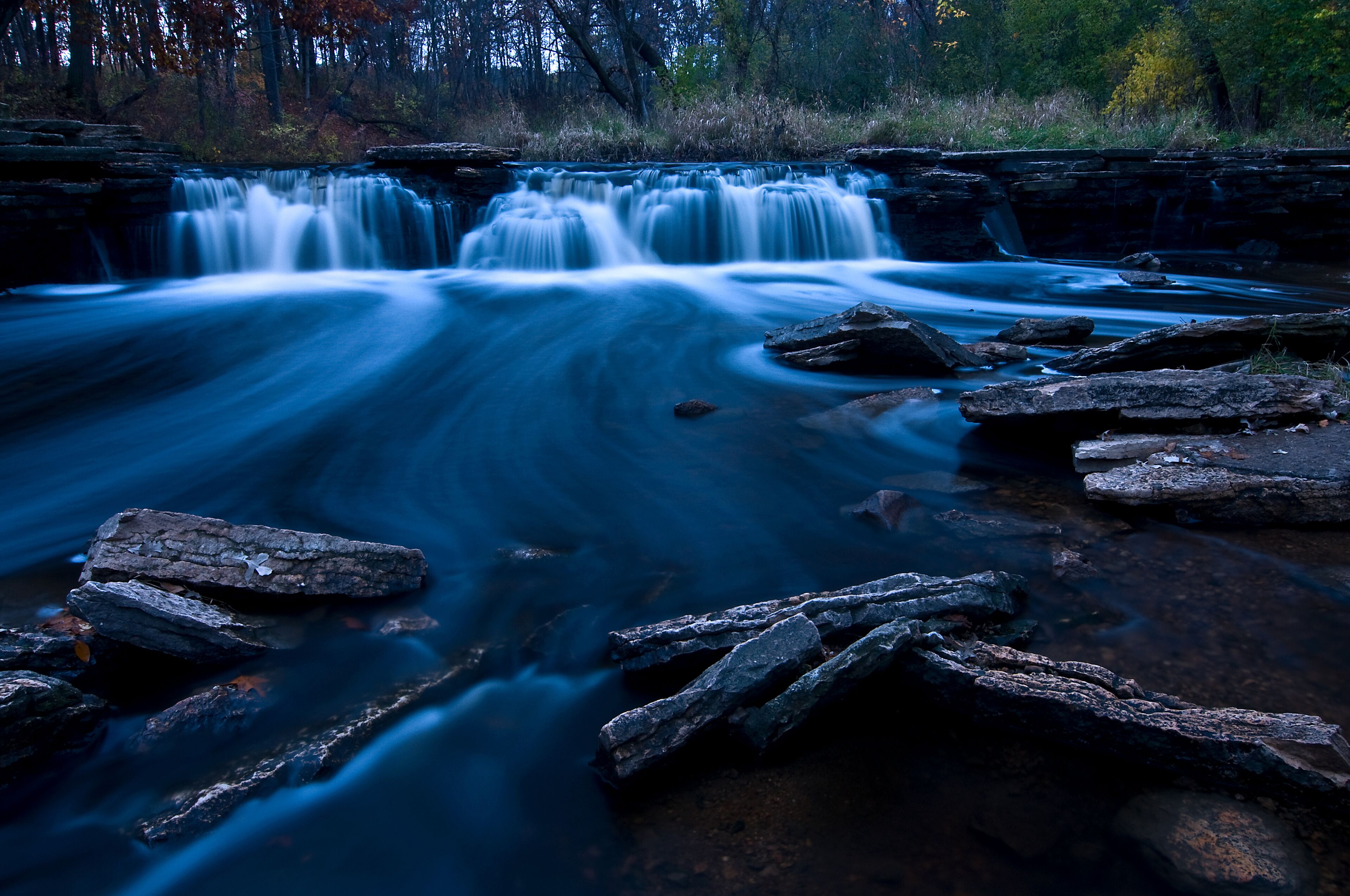 A flowing waterfall at dusk.