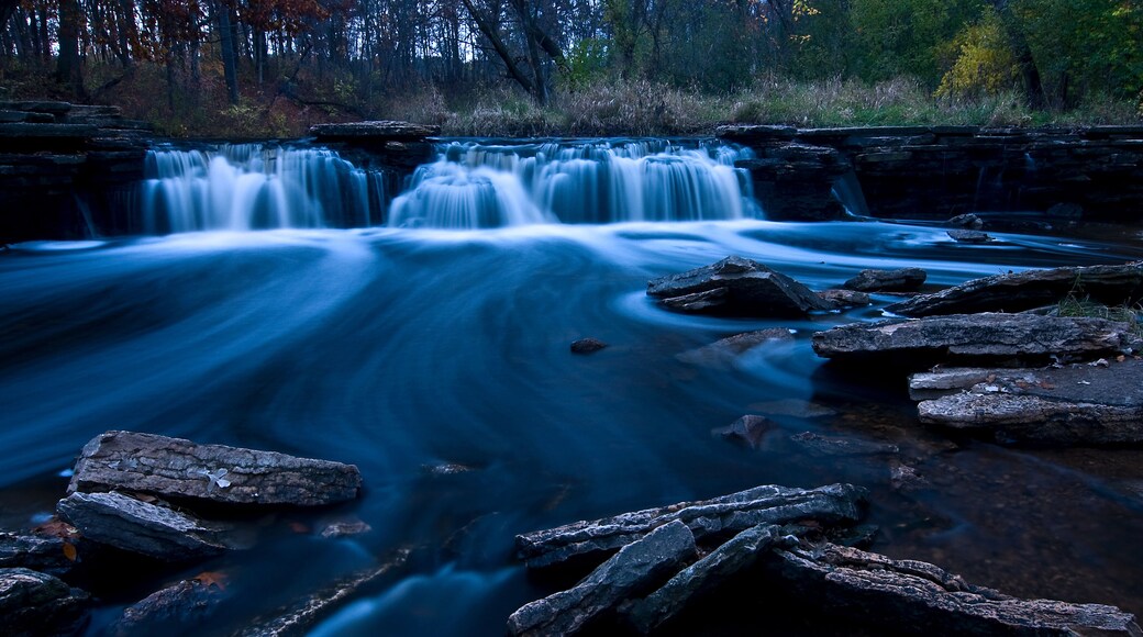 A flowing waterfall at dusk.