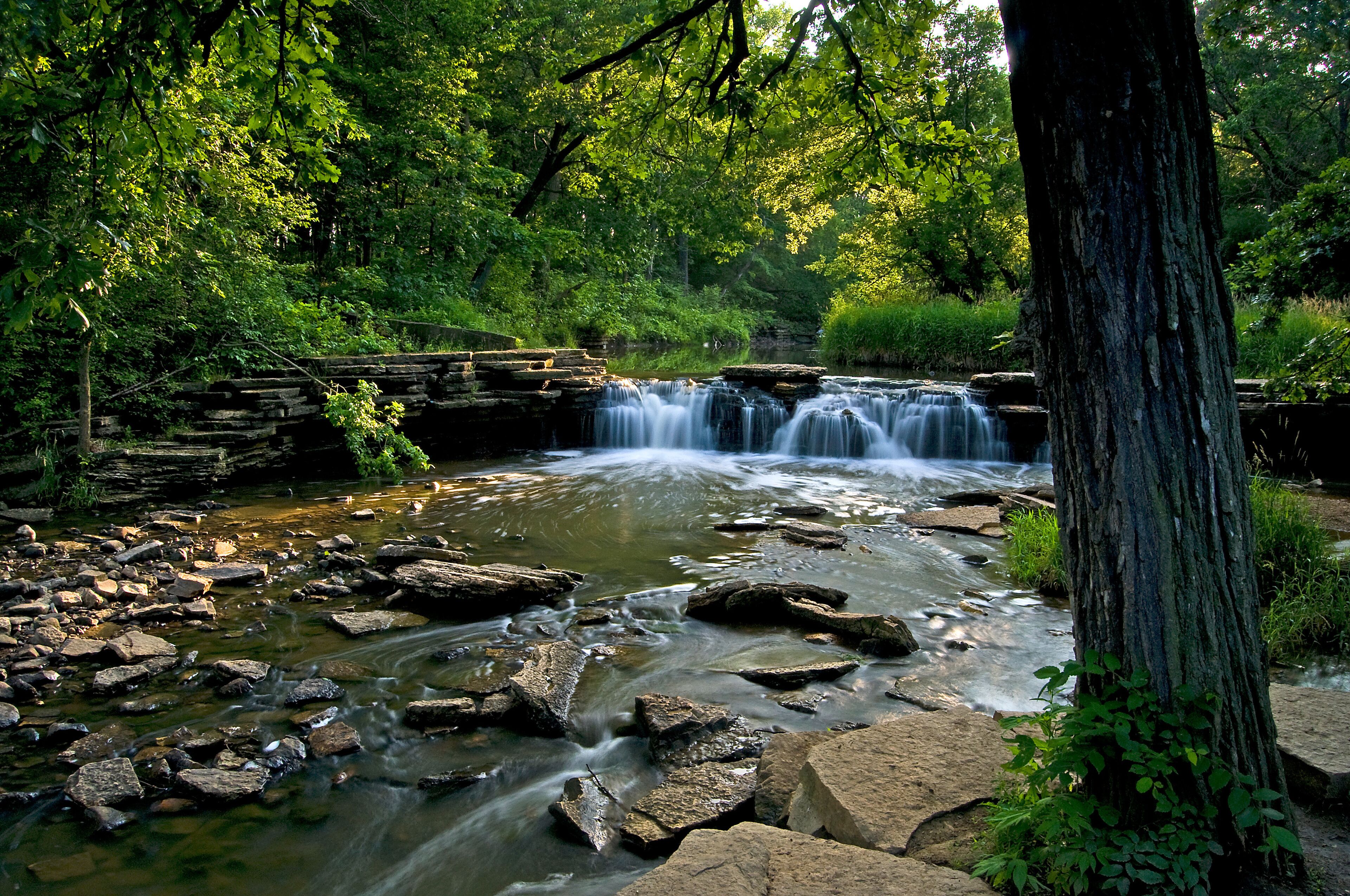 A stream swollen with spring rains spills over a picturesque waterfall.