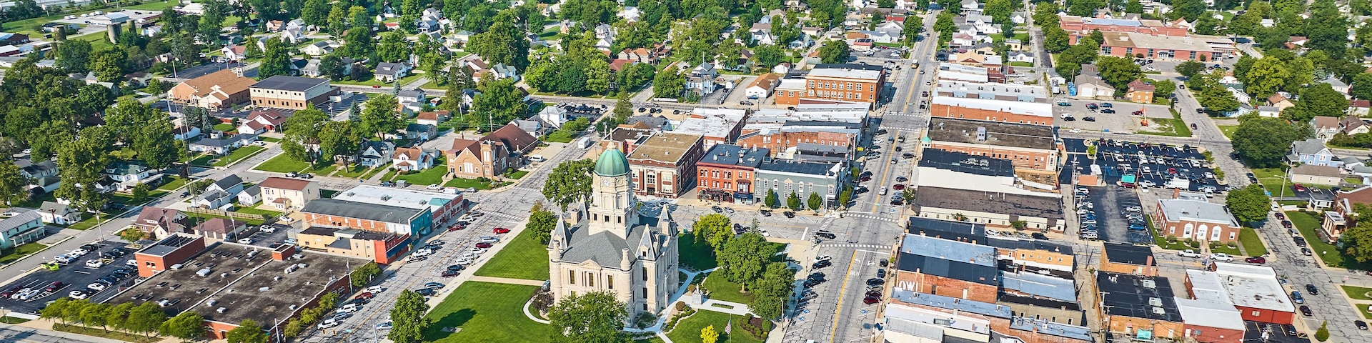 Aerial downtown Columbia City with courthouse and shops with distant houses