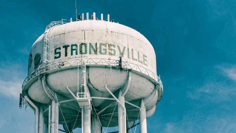 A water tower with 'STRONGSVILLE' written on it.