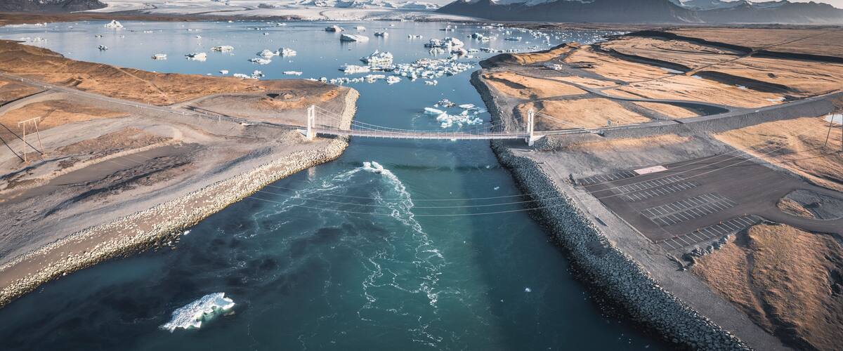 ice block over black sand in diamond beach at sunrise from aerial view