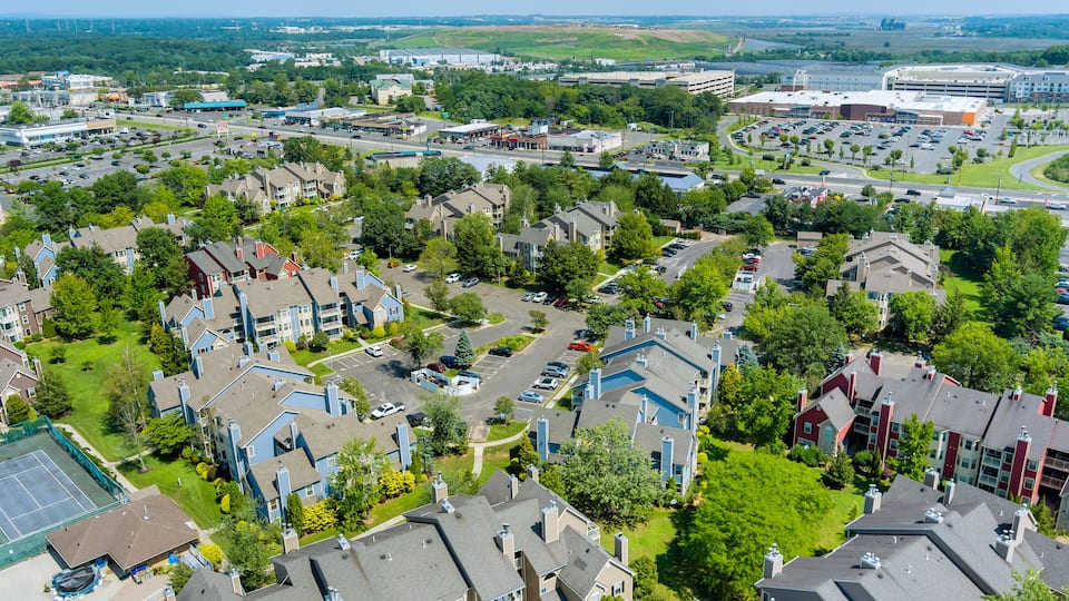 Landscape scenic aerial view of suburban apartment settlement in USA with a beautiful town detached houses near 18 road in East Brunswick, New Jersey USA