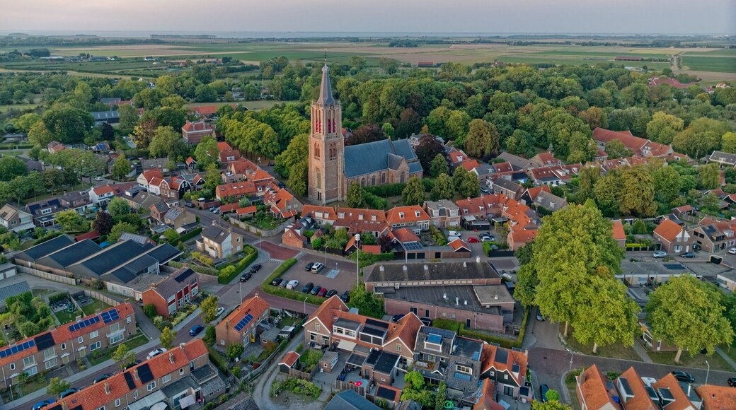 Typical Dutch church Geerteskerk in small town Kloetinge aerial view