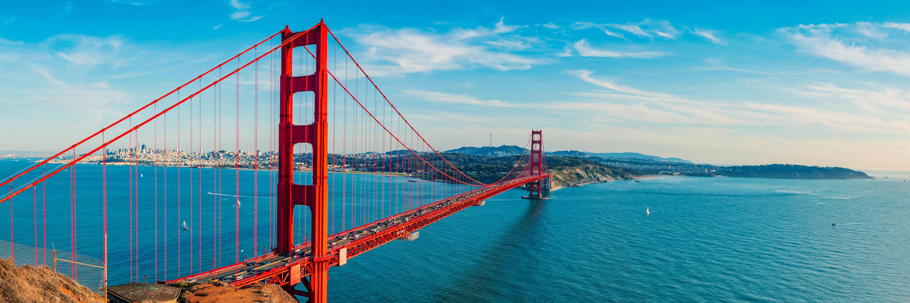 The Golden Gate Bridge spanning the San Francisco Bay with a cityscape in the background.
