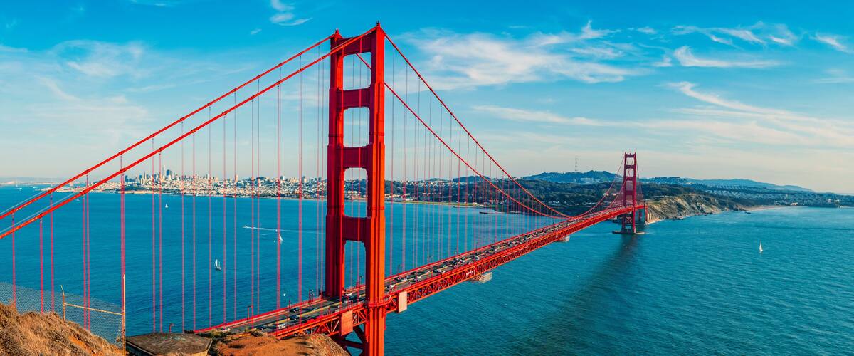 The Golden Gate Bridge spanning the San Francisco Bay with a cityscape in the background.