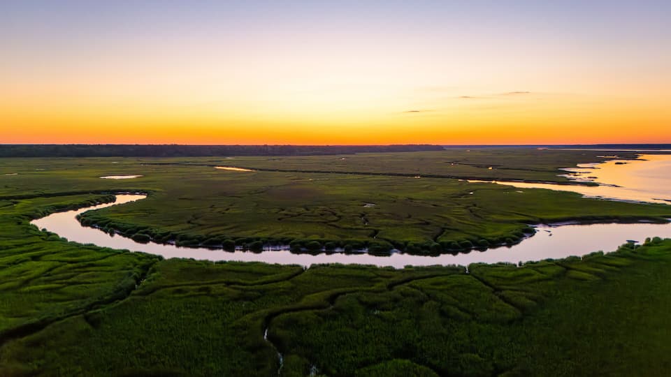Sunset over marsh landscape with reflection