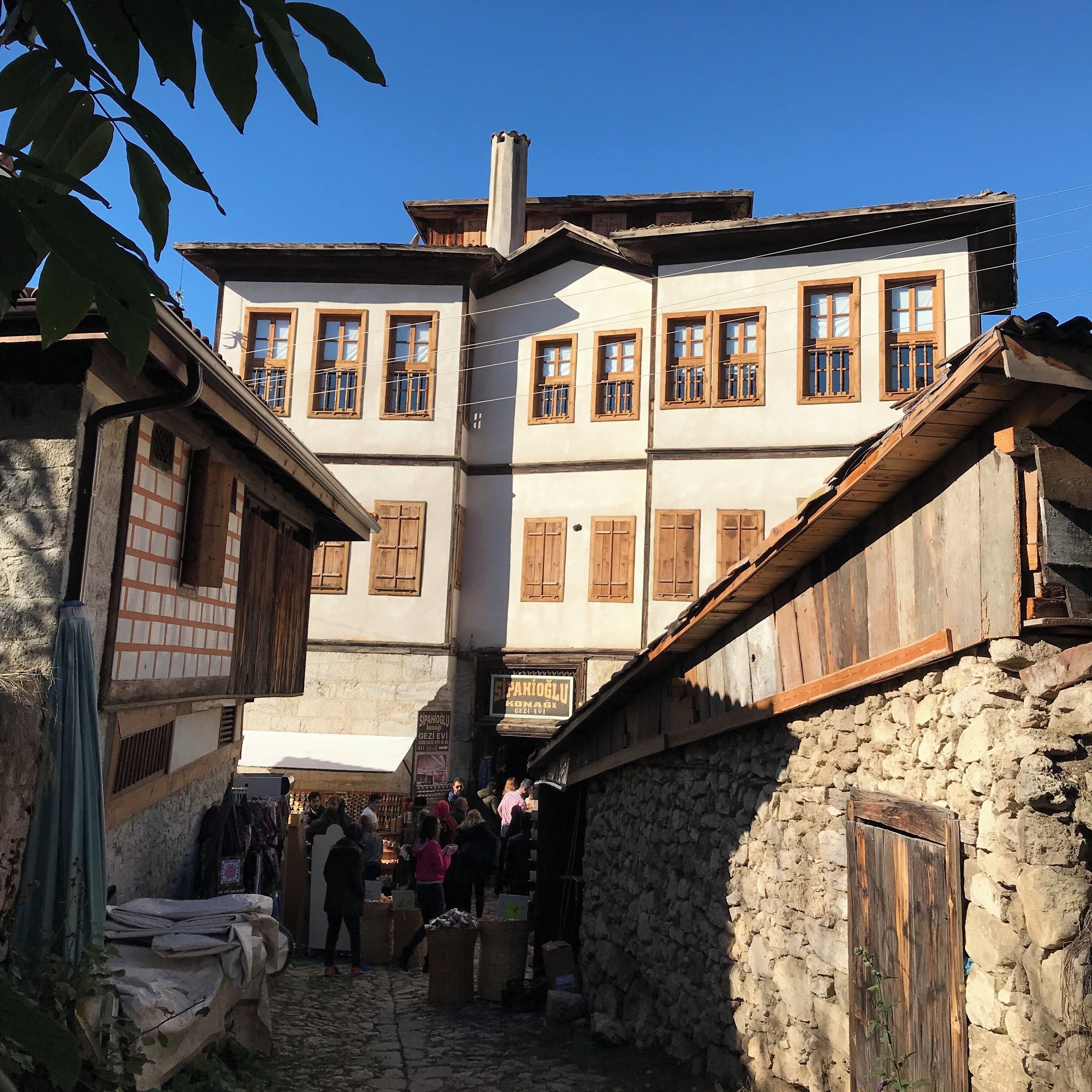 A traditional market street with stone buildings and wooden shutters.