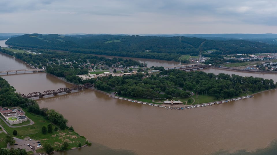A river winding through a town surrounded by hills.