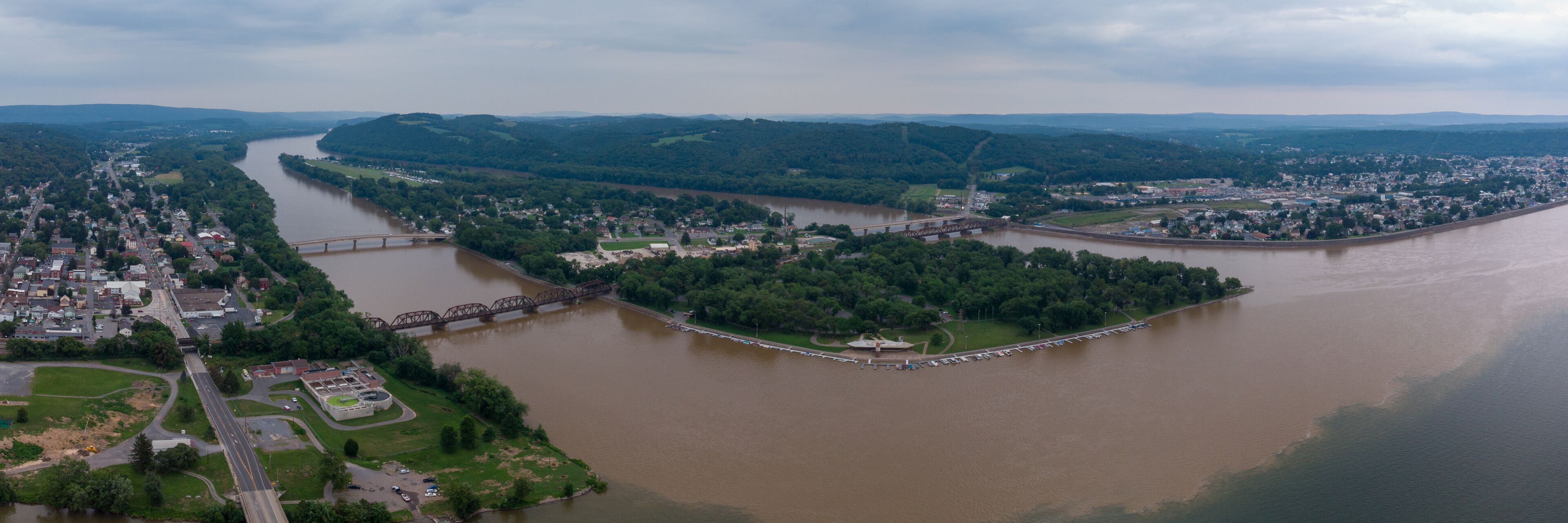 A river winding through a town surrounded by hills.