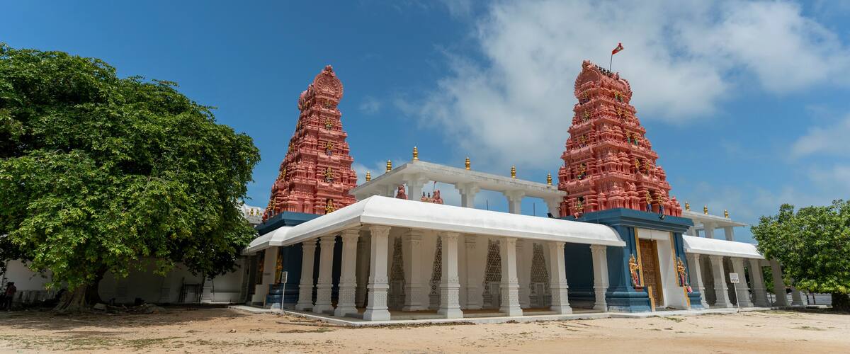 A temple with two tall spires and a white entrance hall.