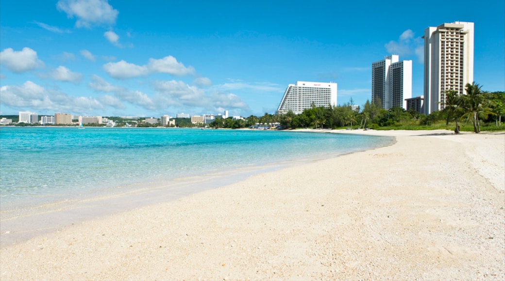Guam showing a beach, tropical scenes and a luxury hotel or resort
