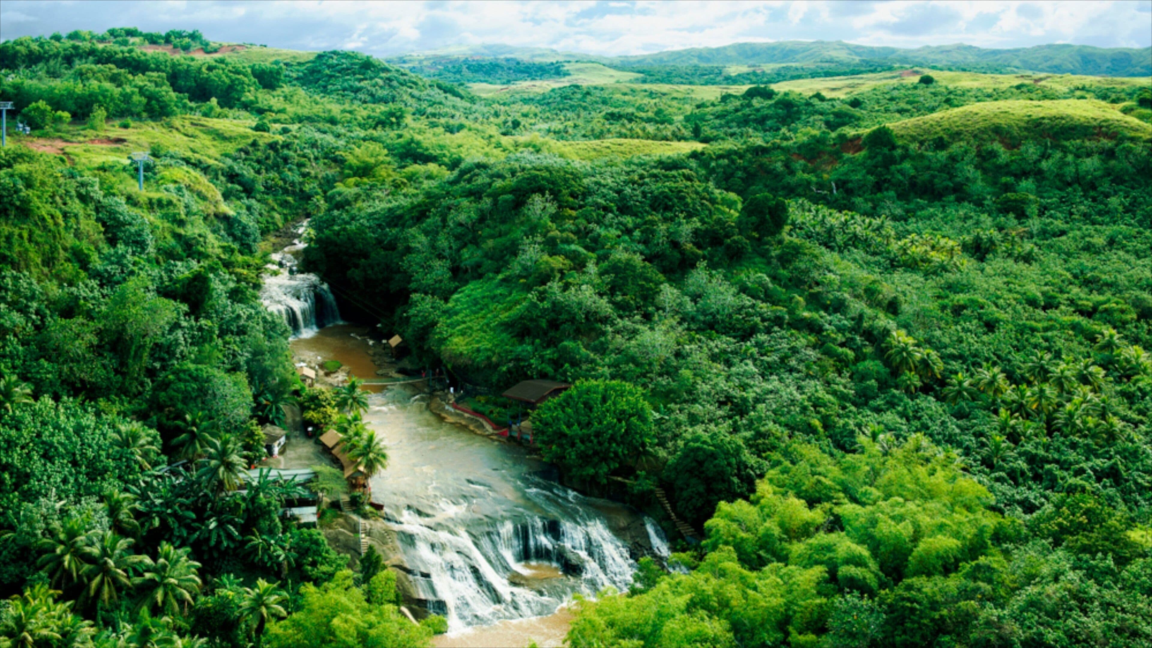 Guam featuring landscape views, rapids and a waterfall