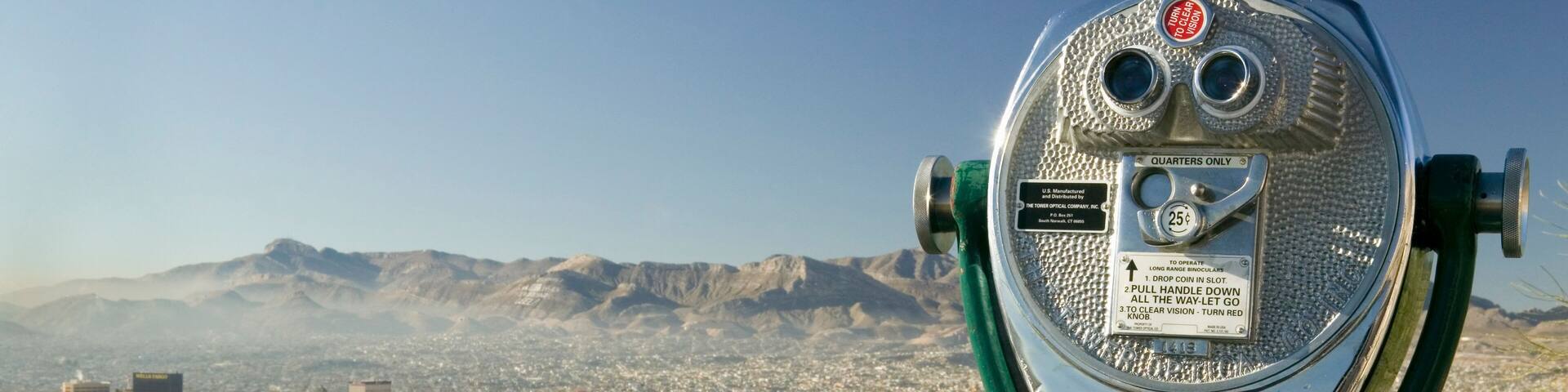 Long range binoculars for tourists and panoramic view of skyline and downtown of El Paso Texas looking toward Juarez, Mexico