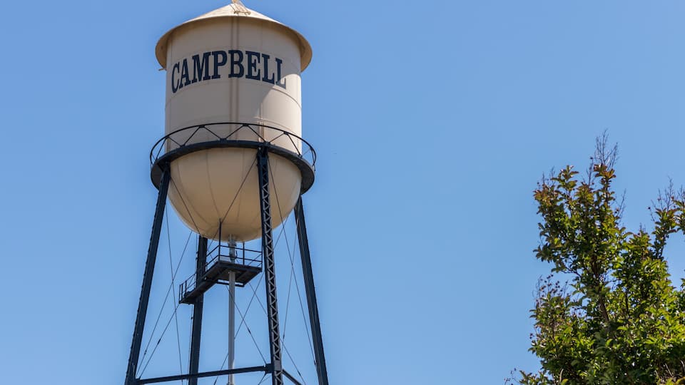 A water tower labeled CAMPBELL against a clear blue sky.