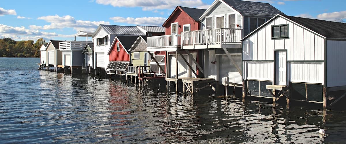 A row of boat houses on Canandaigua Lake in the Finger Lakes region of New York. Boathouses on Canandaigua Lake, New York, Shutterstock ID 131355452, purchase_order: SP-1269 HA 2018 Batch 1, Order: ,
