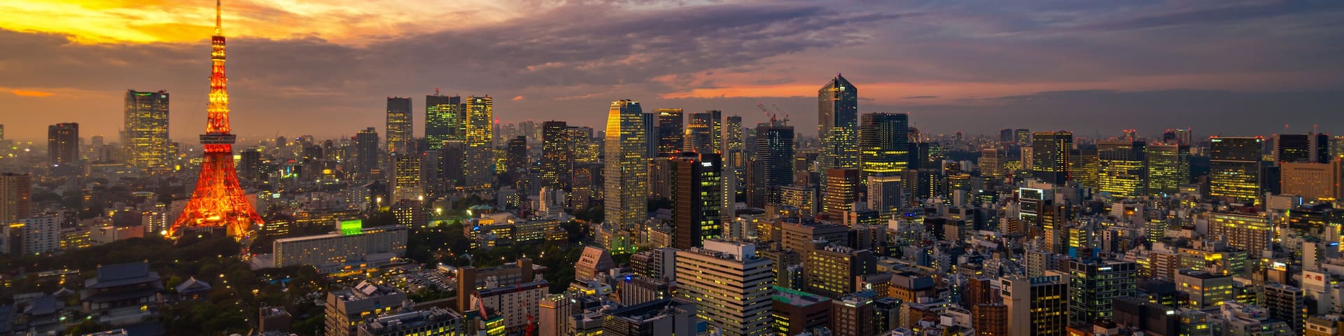 Panorama of Tokyo city skyline view and Tokyo Tower building at Japan with sunset and colorful sky. Beautiful of cloud and sky in dusk and twillight. Tokyo financial and business center zone.
