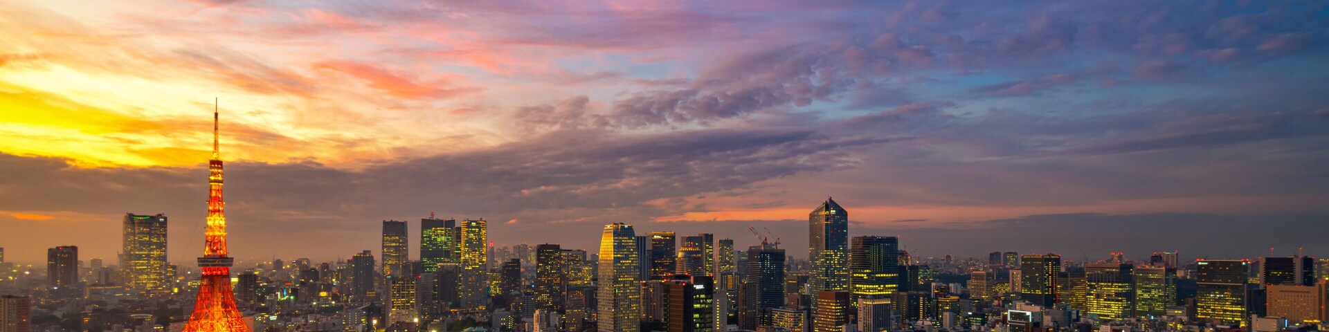 Panorama of Tokyo city skyline view and Tokyo Tower building at Japan with sunset and colorful sky. Beautiful of cloud and sky in dusk and twillight. Tokyo financial and business center zone.