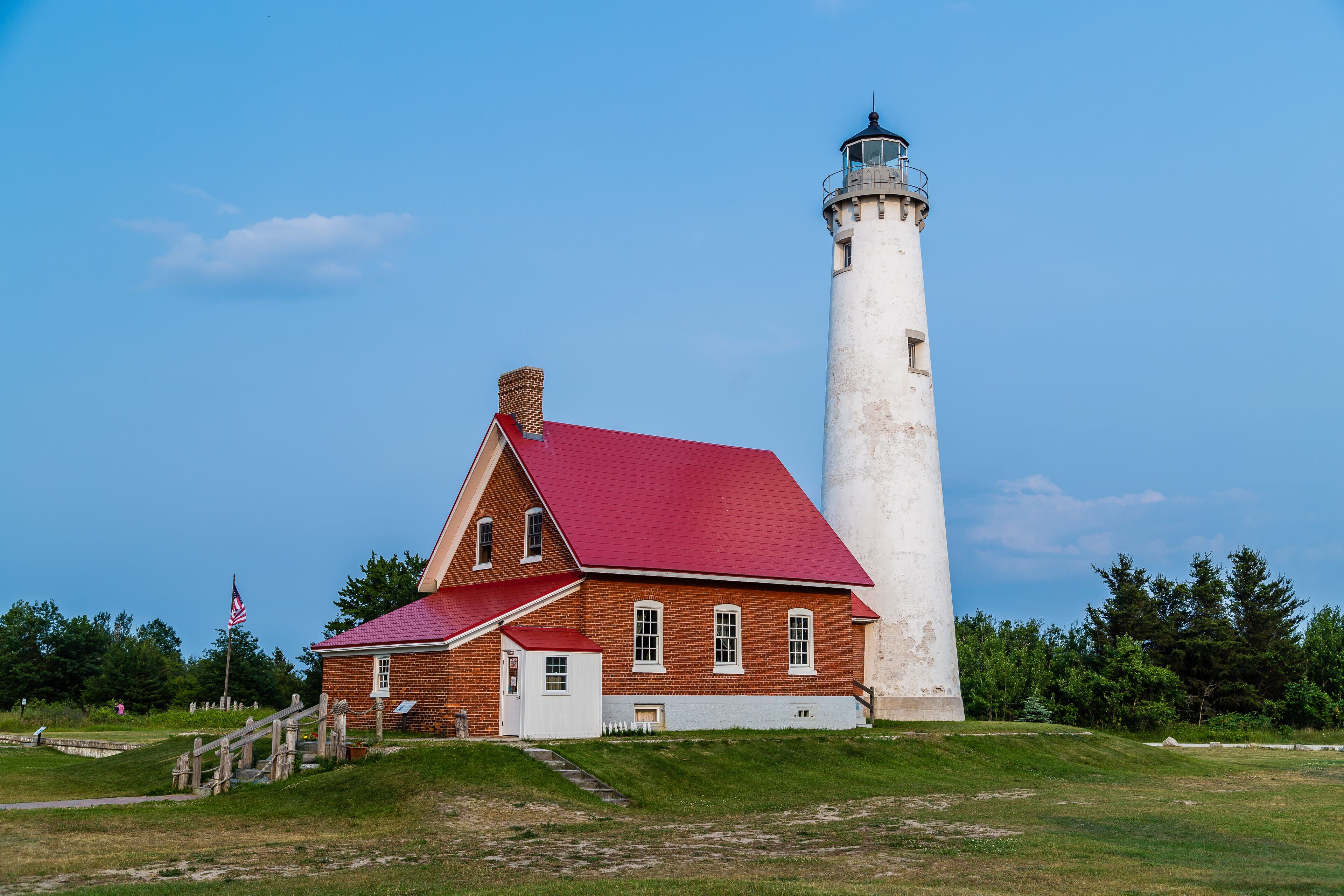 Tawas point lighthouse in the evening against blue sky