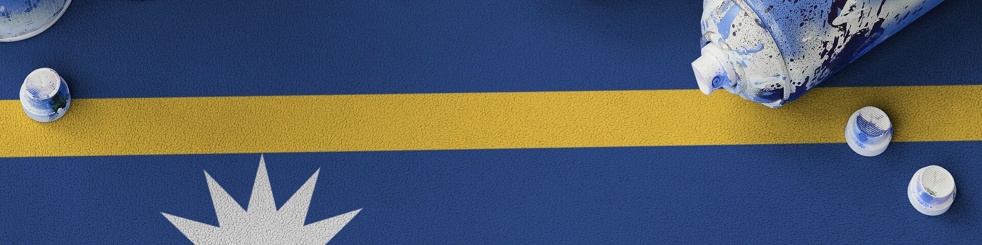 Nauru flag and few used aerosol spray cans for graffiti painting. Street art culture concept, vandalism problems