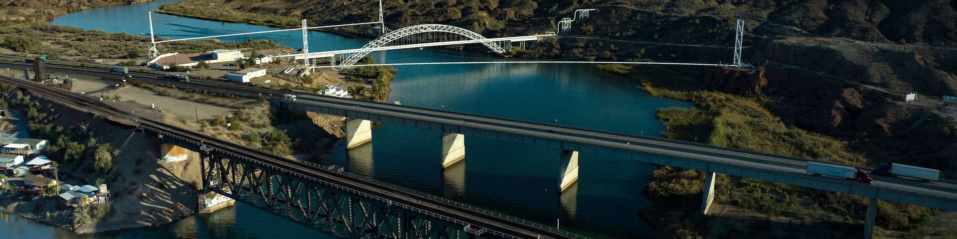 OCTOBER 17, 2023, USA - Interstate Highway 40 crosses Colorado River at Needles, CA. showing trains, highways, bridges and waterways