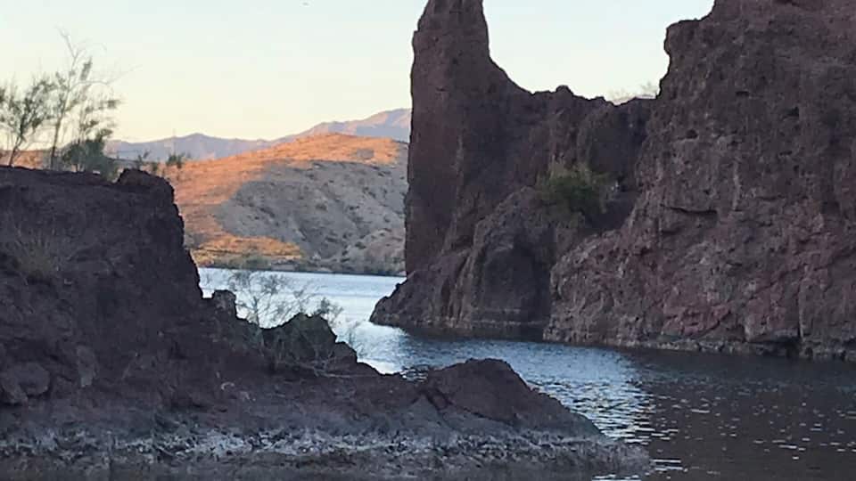 A river with rocky formations and a clear sky.