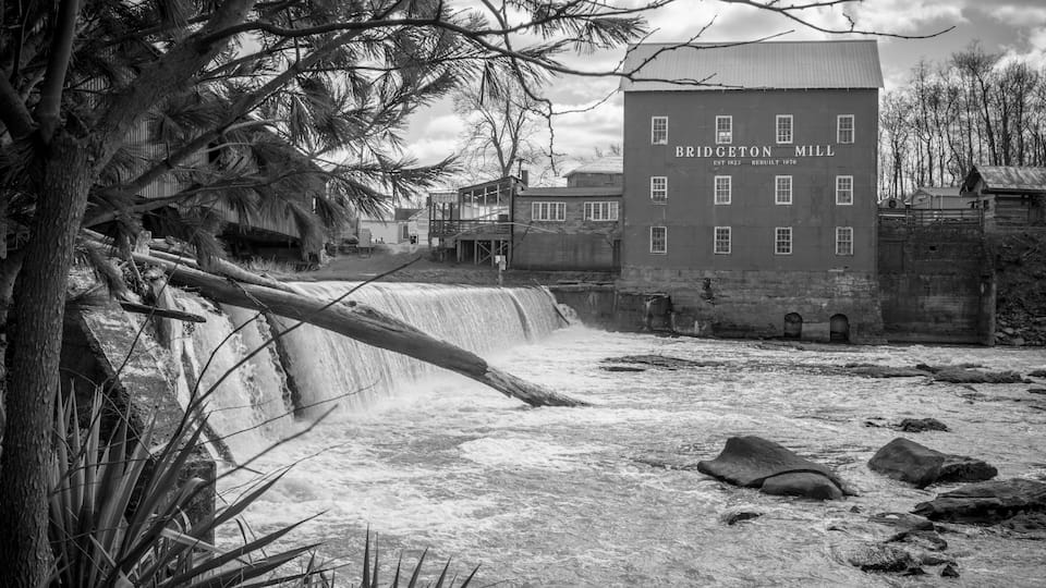 A waterfall, a building labeled 'Bridgeton Mill', and surrounding trees.