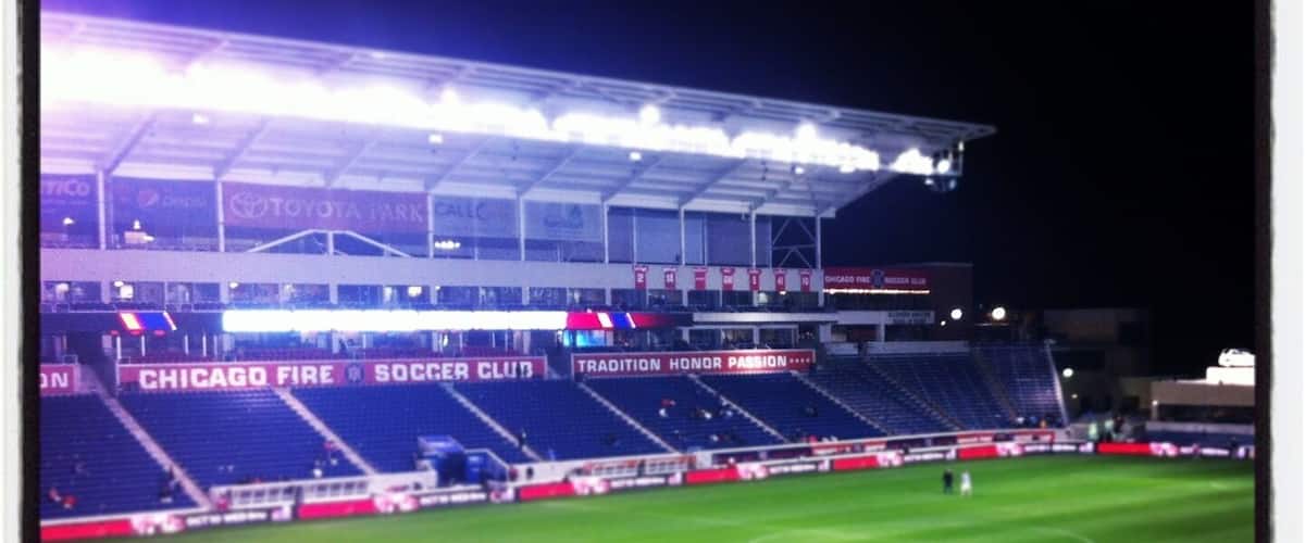 A large, empty stadium with visible advertisements for Toyota and Chicago Fire Soccer Club.