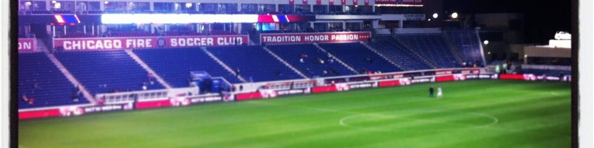 A large, empty stadium with visible advertisements for Toyota and Chicago Fire Soccer Club.
