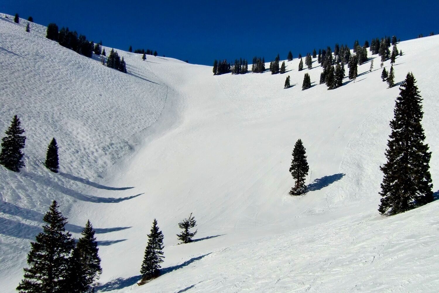 Years before it was officially open to skiers, China Bowl had been named for its headwall, visible now from the top of Orient Express, Chair 21.  This long limestone formation reminded early Vail skiers of the Great Wall of China.