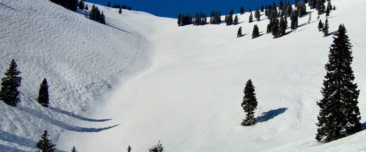 Years before it was officially open to skiers, China Bowl had been named for its headwall, visible now from the top of Orient Express, Chair 21. This long limestone formation reminded early Vail skiers of the Great Wall of China.