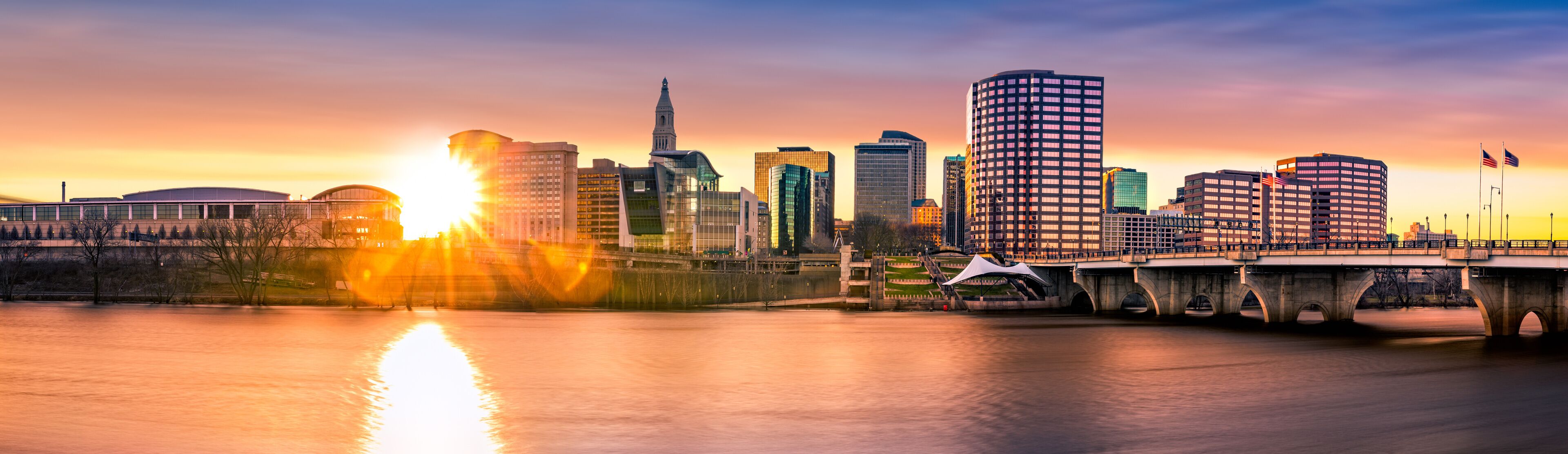 Hartford skyline and Founders Bridge at sunset. Hartford is the capital of Connecticut.