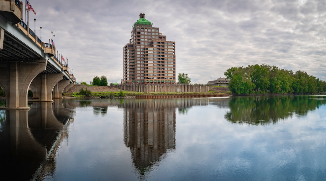 Peaceful panoramic landscape over Connecticut River with the view of Founder's Bridge and buildings and forest on the riverbank on East Hartford.