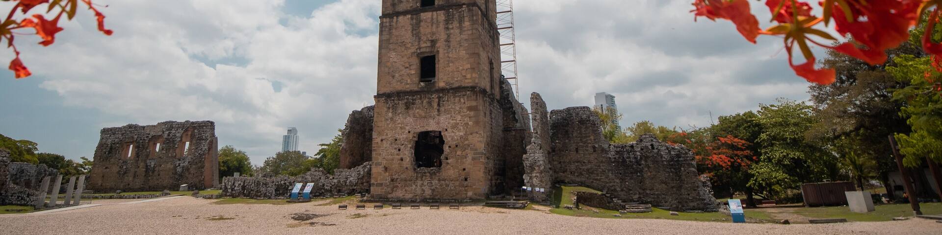 View of Panama Viejo historical city, first settlement of panama city, main square and evangelino Jimenez tower visible, big panama backdrop in the background with skyscrapers.