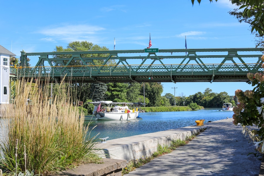 Sailboats passing under a raised lift bridge at Brockport, New York