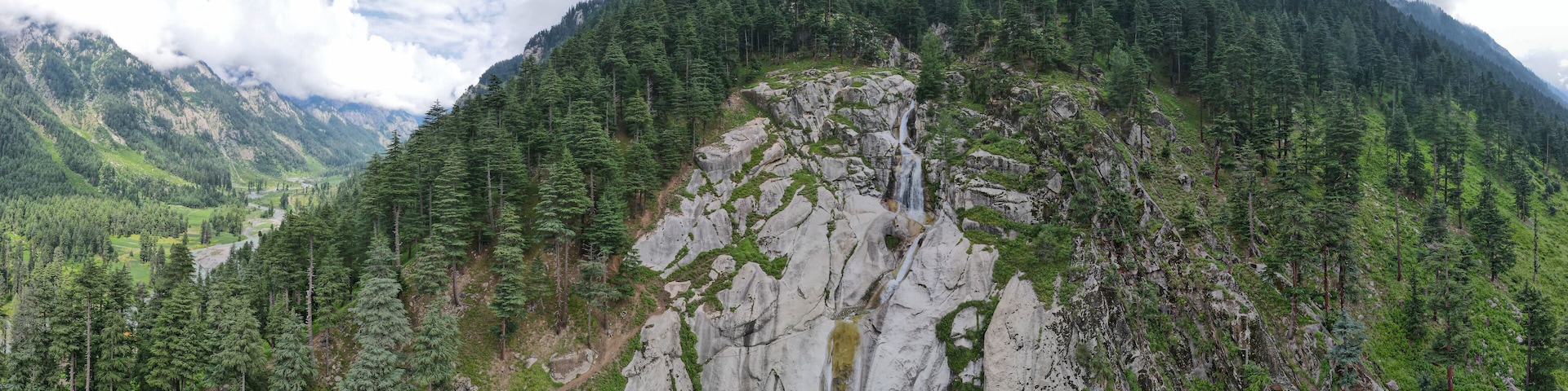 A 180-degree aerial panorama of Kumrat waterfalls and its surrounding mountains and Kumrat valley, located in Pakistan.