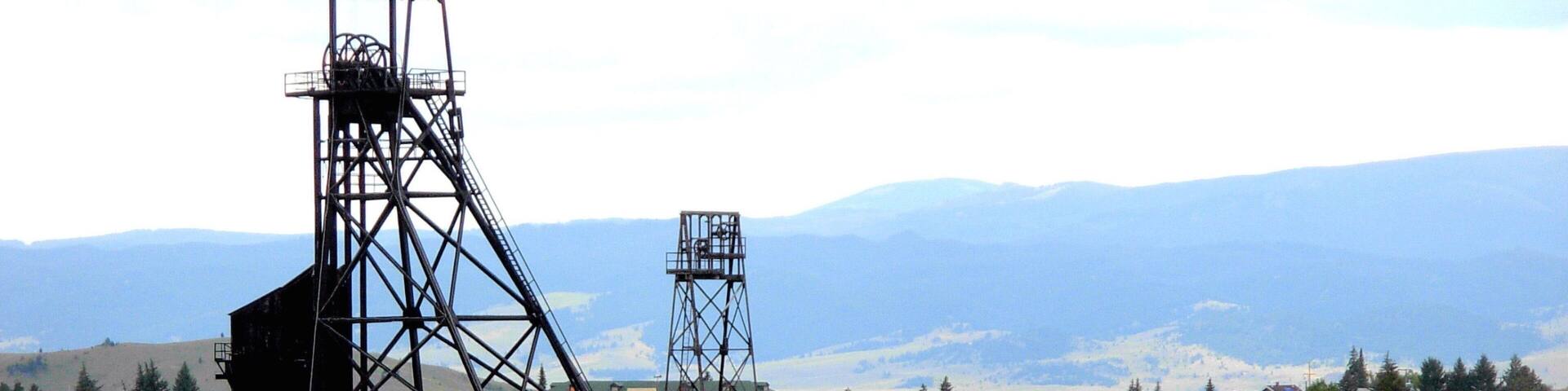 Butte featuring industrial elements, a small town or village and mountains