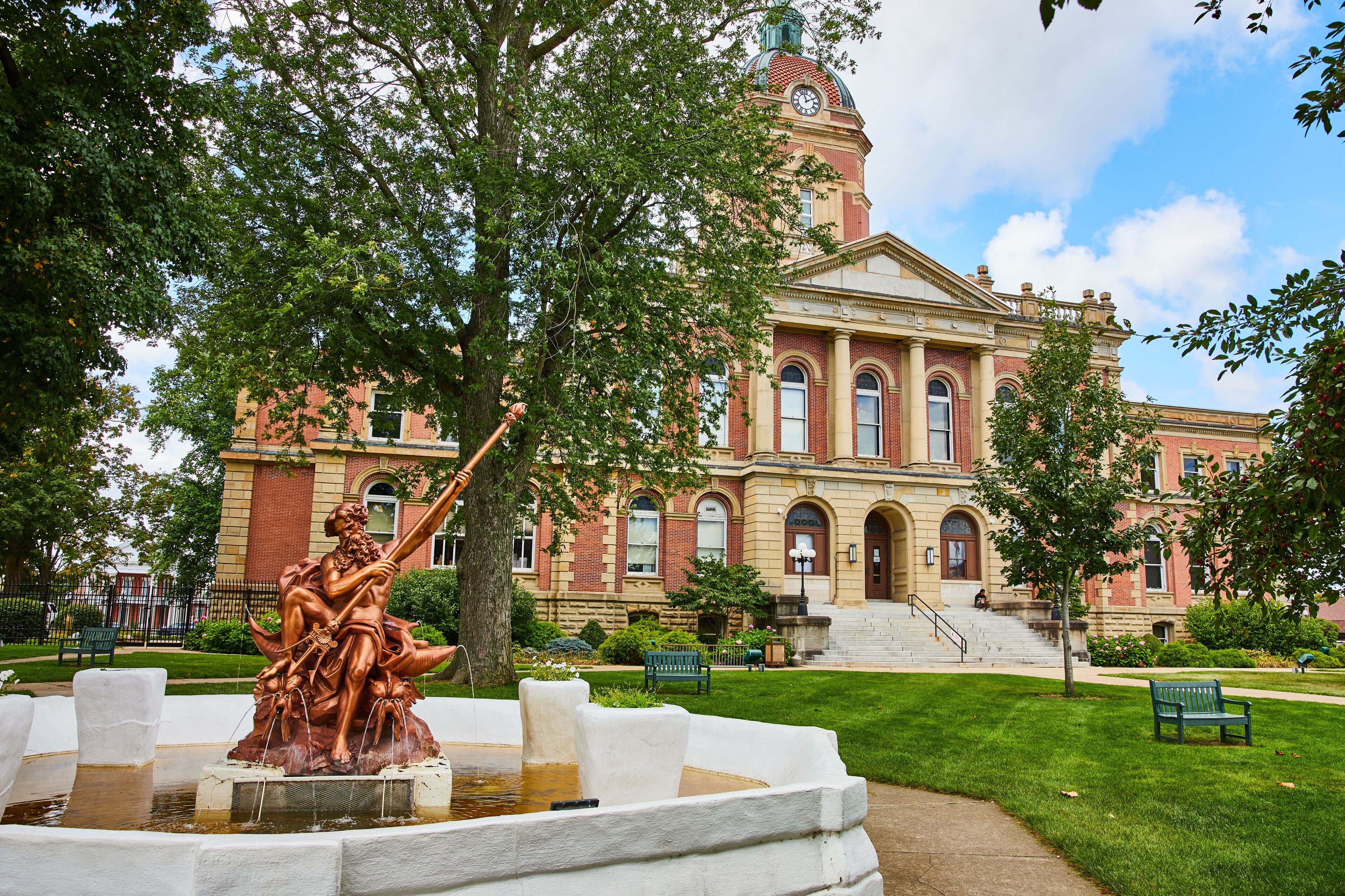 Poseidon bronze statue fountain at Elkhart County courthouse on summer day, law and order, Indiana