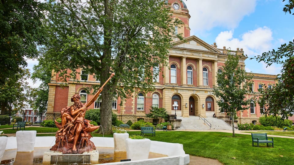 Poseidon bronze statue fountain at Elkhart County courthouse on summer day, law and order, Indiana