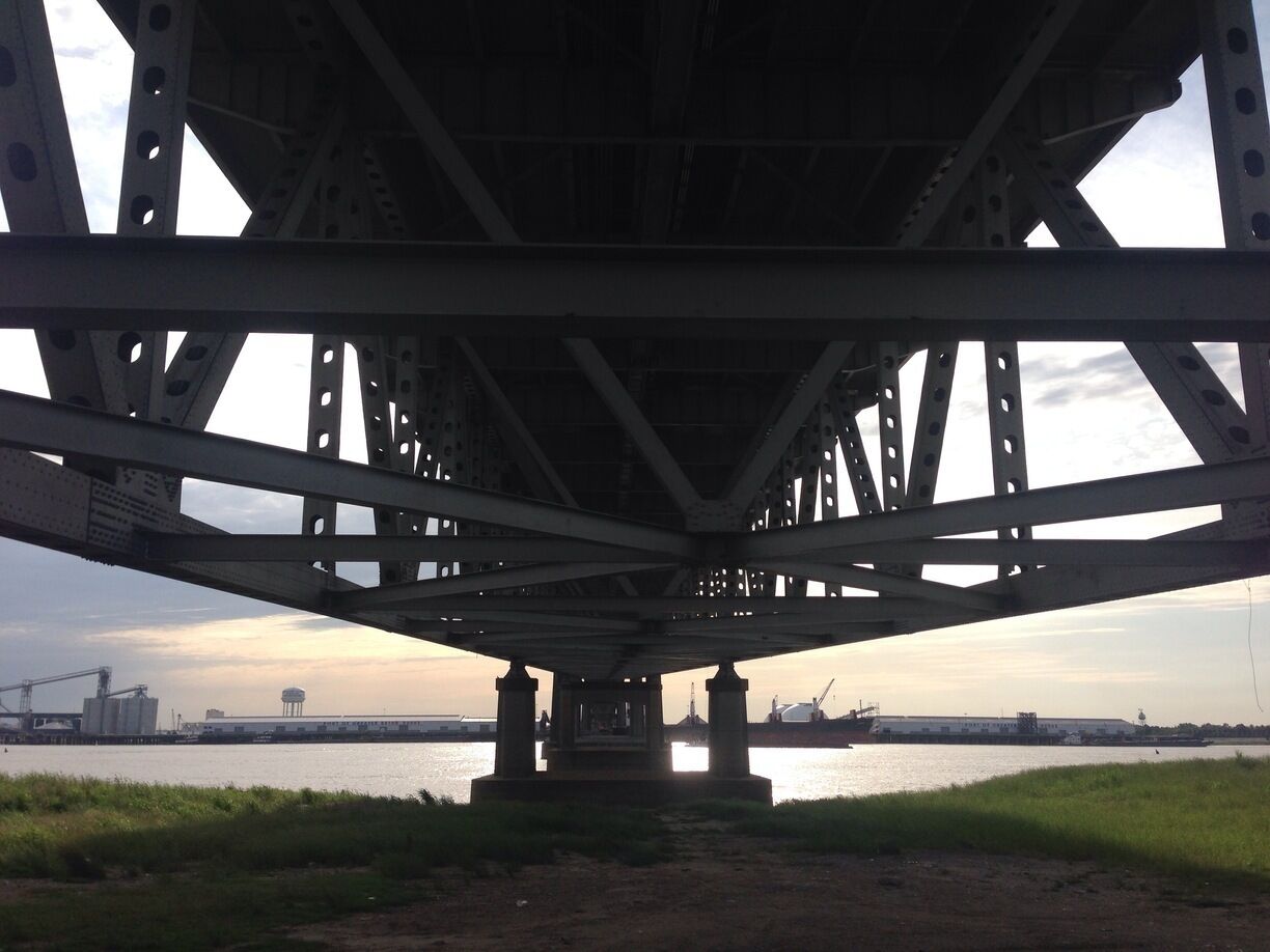 Sunset on the Mississippi River, under a bridge. 