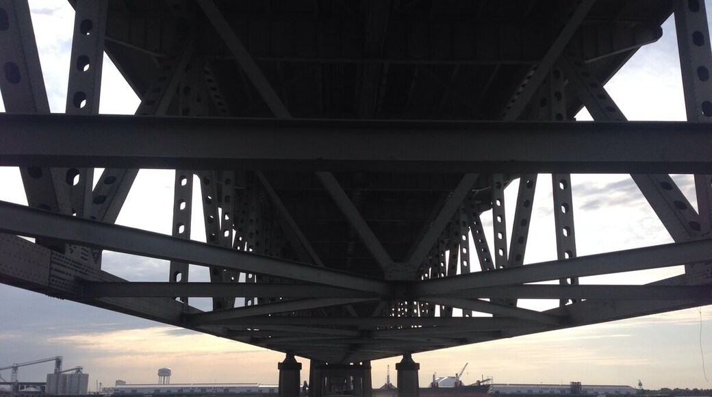 Sunset on the Mississippi River, under a bridge.