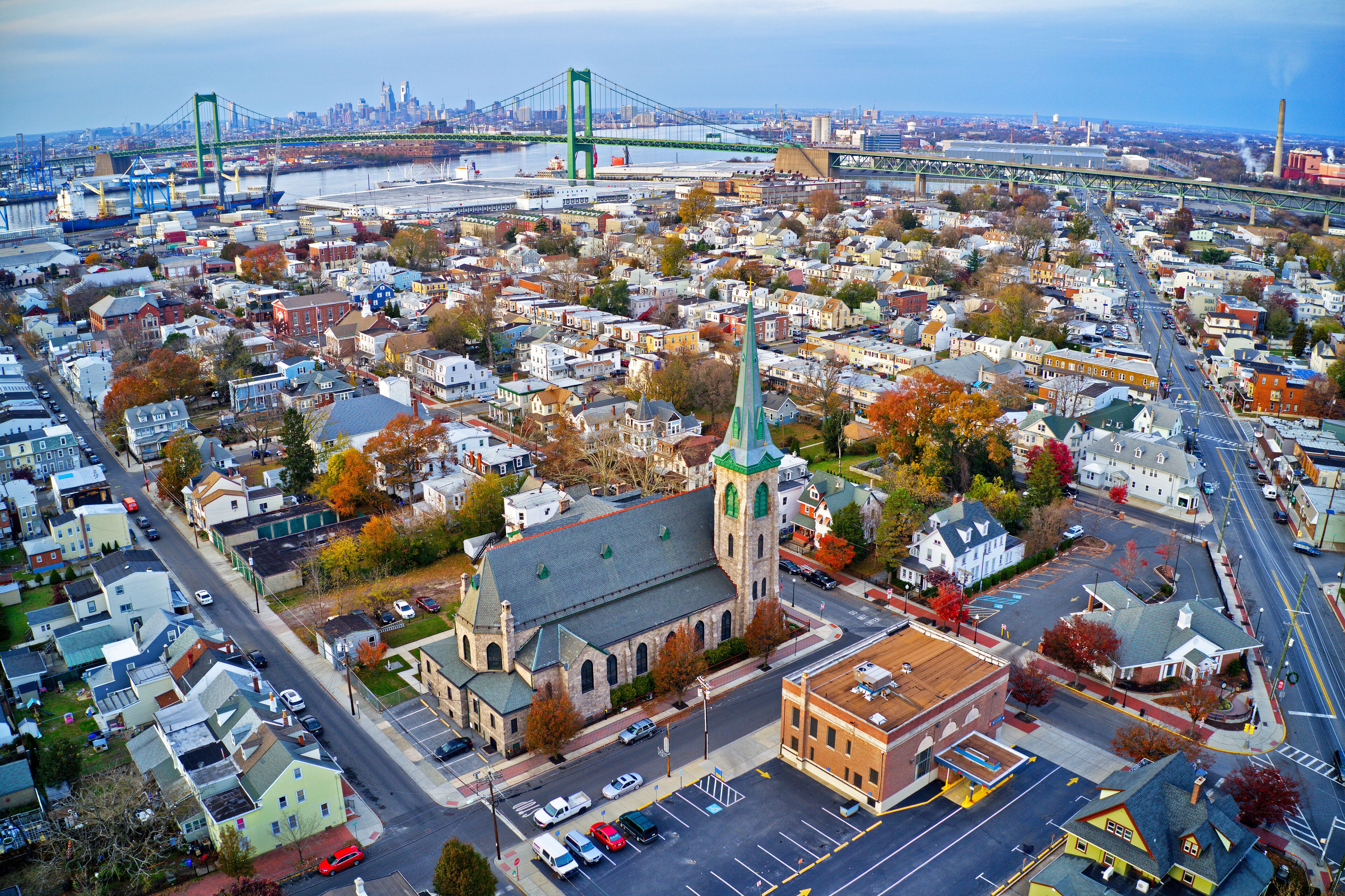 An aerial view of a city with a prominent church, a bridge, and a waterfront.