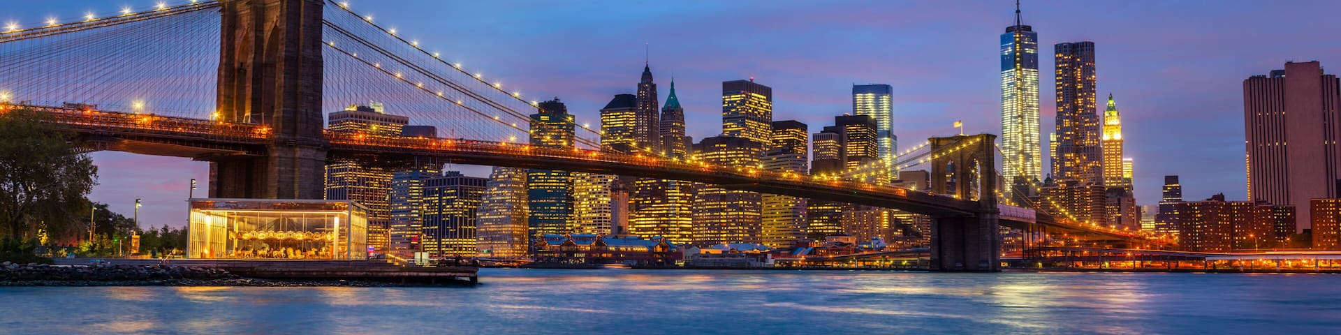 Panorama of Brooklyn Bridge with lights and reflections