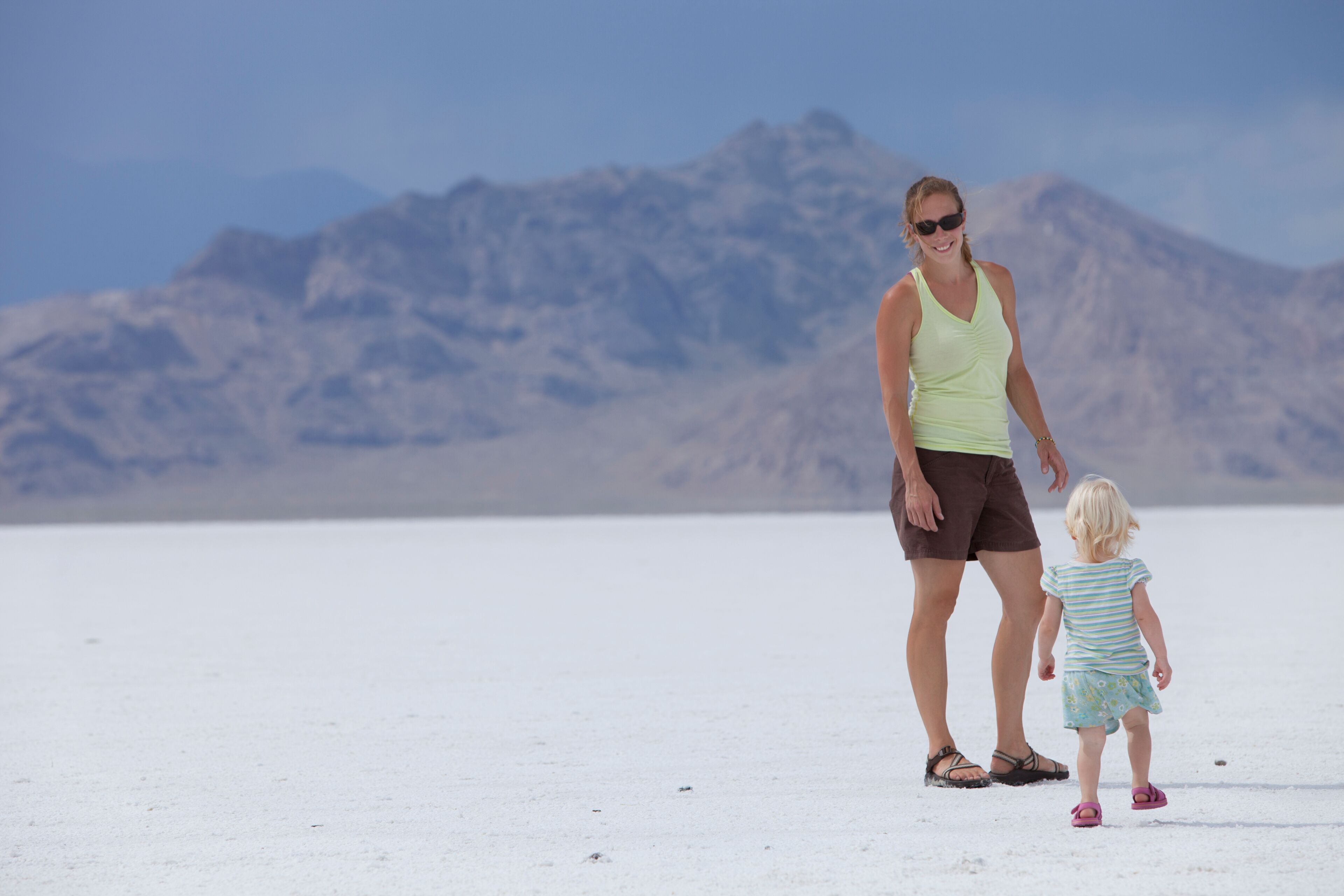 Female adult and young female toddler standing on the Utah salt flats