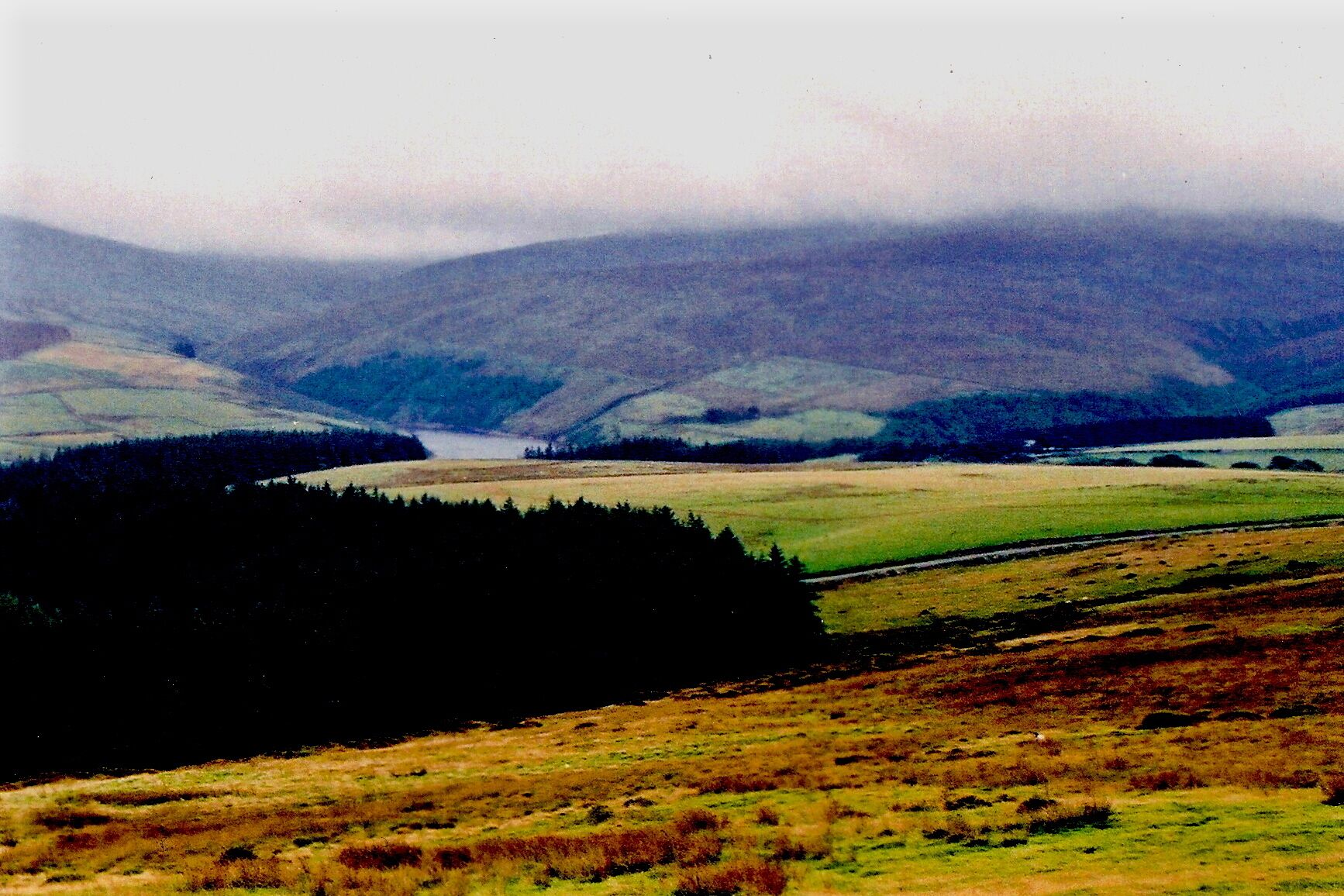 Druidale Road - Southwest of Sulby Reservoir -Hills View is to the southeast. Shown in the distance at the middle of the image is a portion of Sulby Reservoir.