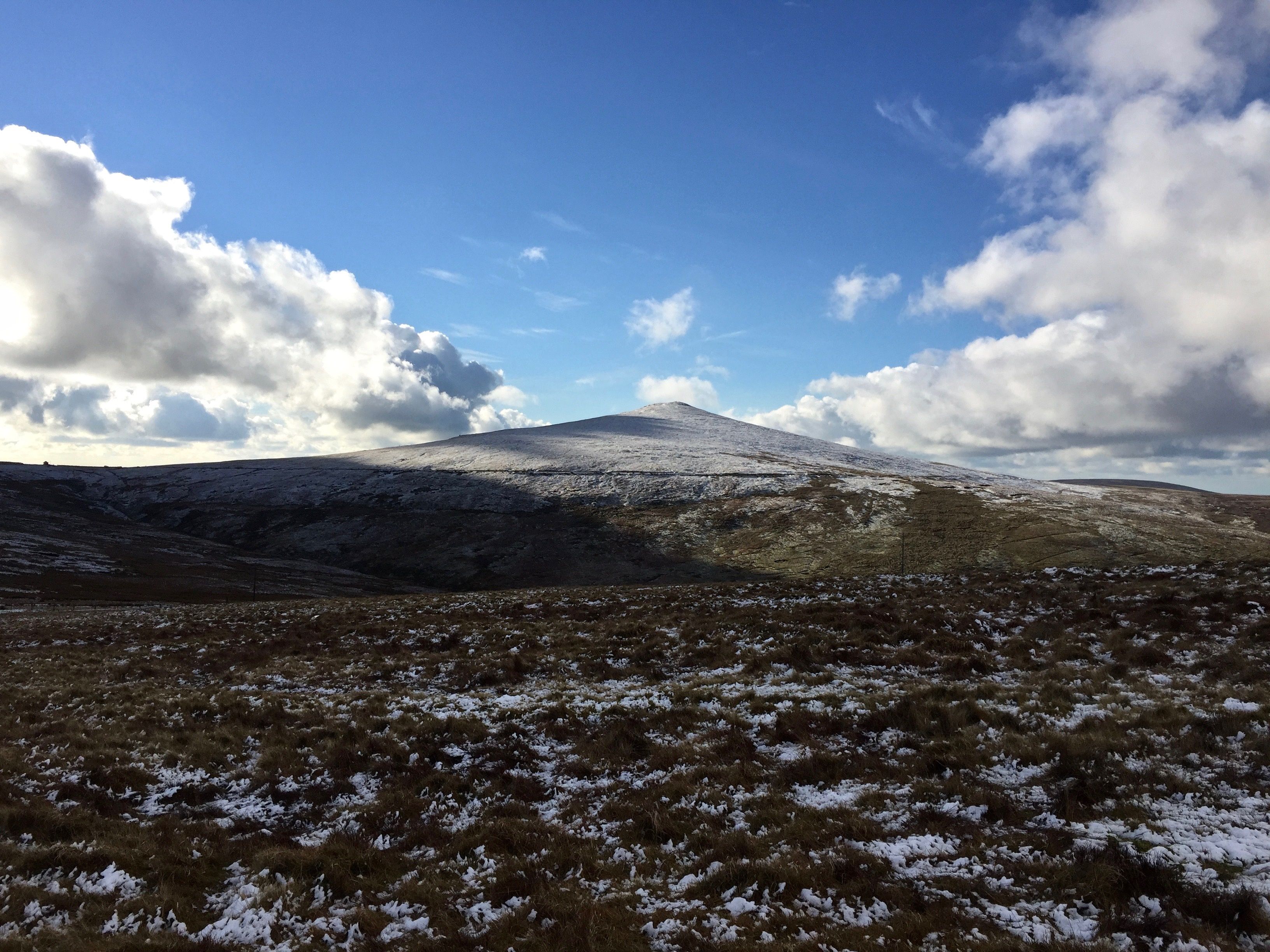 A snow-covered mountain with a clear sky.