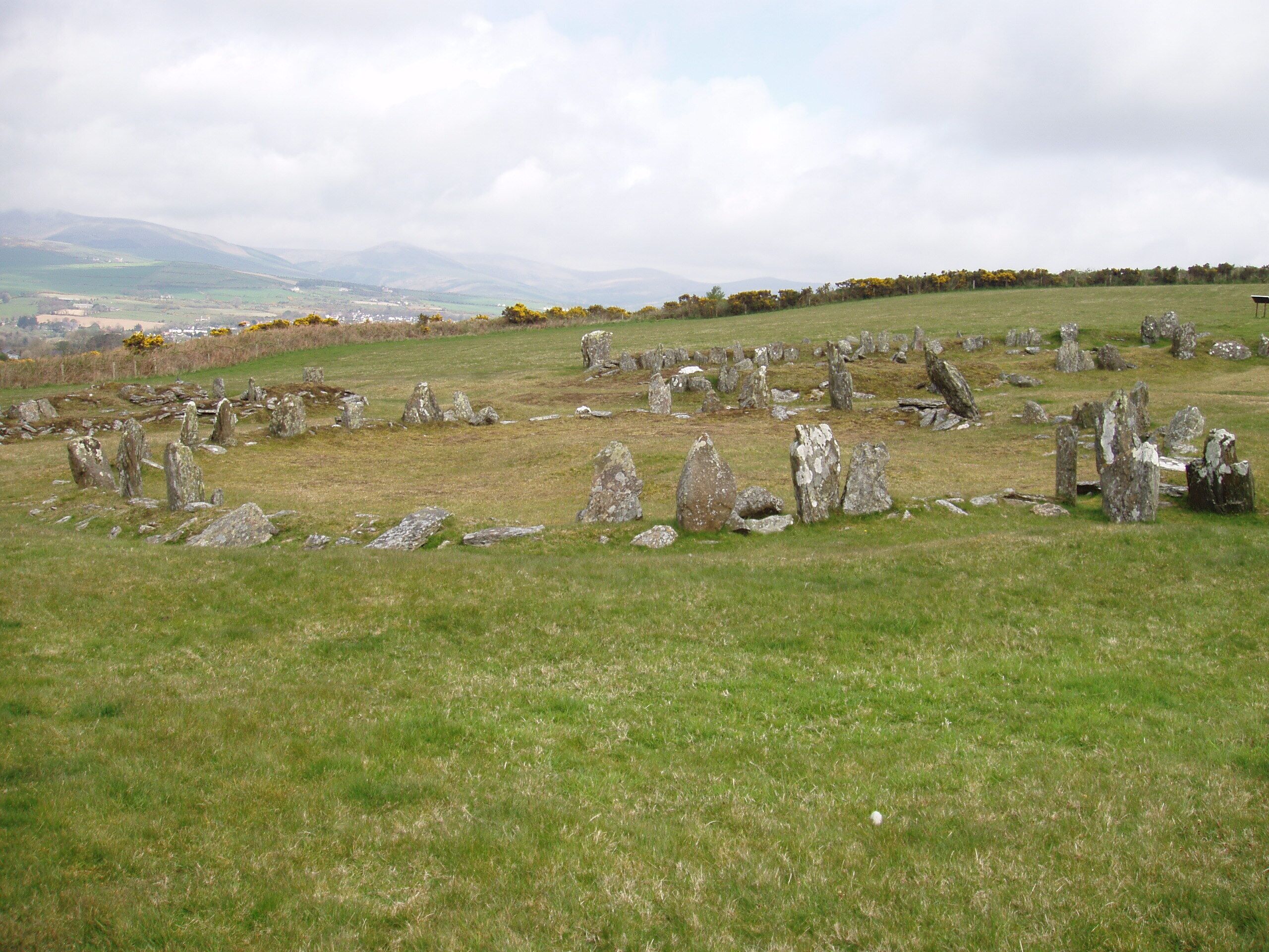 Part of the Manx Heritage Trail, The Braaid is the site of an ancient Celtic-Norse era community. Remnants of a roundhouse in the foreground, c. 650 A.D. and remnants of two longhouses in the background, c. 950 A.D. can be seen here situated on the rolling hills of Marown in central Isle of Man.
