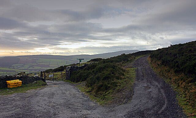 Track junction above Greeba. The track to the right leads west and down to Ballig. Through the gate is the road to Greeba.