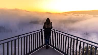 Woman Overlooking The Mississippi River At Sunrise From Iowa With Low Clouds Below