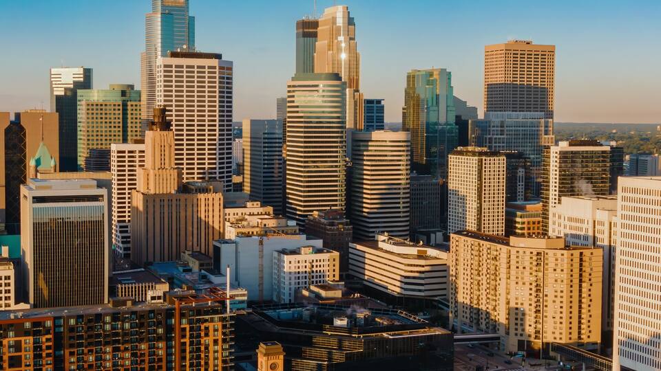 High-angle view of Minneapolis skyline at sunrise. Modern skyscrapers and city streets. Urban landscape. Downtown West, Minneapolis, Minnesota, United States